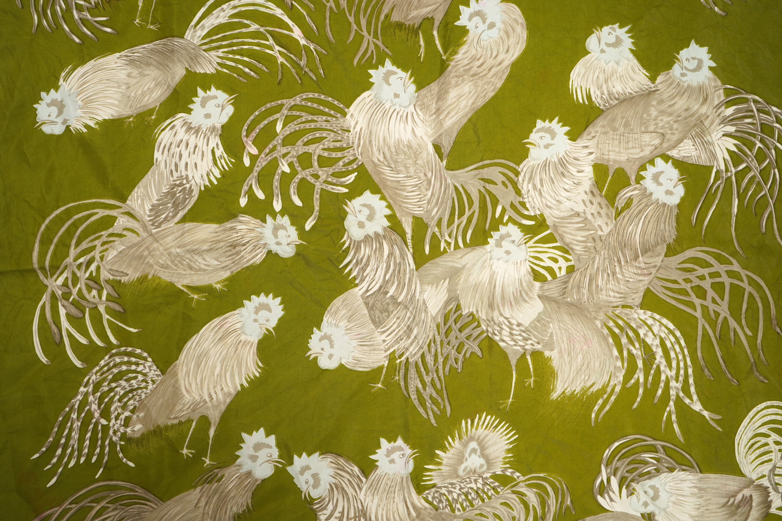 A collection of three Hermes silk scarves and a Chanel monogram example